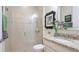 Well-lit bathroom featuring a glass-enclosed shower and granite vanity at 11625 Parrotfish St, Venice, FL 34292
