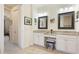 Bright bathroom featuring dual vanities, framed mirrors, granite counters, and tile flooring at 11625 Parrotfish St, Venice, FL 34292