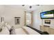 Comfortable bedroom with TV, side table, and window with curtain for natural light at 11625 Parrotfish St, Venice, FL 34292