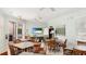 Relaxing clubhouse with tables, chairs, a TV, and a view of the pool at 11625 Parrotfish St, Venice, FL 34292