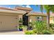 Close-up of front entry with decorative plants, and a brick paver driveway at 11625 Parrotfish St, Venice, FL 34292