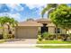 Beautiful single-story home with a well-manicured lawn and mature tropical landscaping at 11625 Parrotfish St, Venice, FL 34292