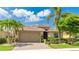Beautiful single-story home with a well-manicured lawn and mature tropical landscaping at 11625 Parrotfish St, Venice, FL 34292