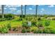 Beautiful garden with colorful flowers and plants, accented by a white picket fence at 11625 Parrotfish St, Venice, FL 34292