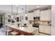 Bright and airy kitchen featuring a large island, pendant lighting, and ample counter space at 11625 Parrotfish St, Venice, FL 34292