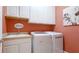 Practical laundry room equipped with white cabinets, a sink, and a modern washer/dryer set at 11625 Parrotfish St, Venice, FL 34292