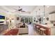 Open-concept living space with tray ceilings, connecting kitchen, and access to the lanai at 11625 Parrotfish St, Venice, FL 34292