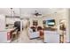 Bright living room with a tray ceiling, open layout, and seamless flow to the kitchen at 11625 Parrotfish St, Venice, FL 34292