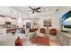 Open-concept living room with stylish decor, blending seamlessly with the adjacent kitchen and dining areas at 11625 Parrotfish St, Venice, FL 34292