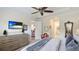 Spacious bedroom with dresser, TV, neutral decor, and access to other rooms at 11625 Parrotfish St, Venice, FL 34292