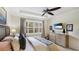 Serene bedroom with tray ceiling, large window, and a dresser offering ample storage space at 11625 Parrotfish St, Venice, FL 34292