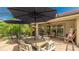 Open-air patio with a wood table and chairs, offering a relaxing and inviting outdoor dining area at 11625 Parrotfish St, Venice, FL 34292