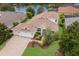 Aerial view of a well-maintained home with a three-car garage, landscaped yard, and waterfront access at 12031 Longview Lake Cir, Lakewood Ranch, FL 34211