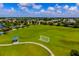 Gorgeous aerial view of a community park with expansive green space, soccer goals, and walking paths at 12031 Longview Lake Cir, Lakewood Ranch, FL 34211
