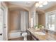 Functional bathroom featuring a shower, vanity with sink, and ample natural light from a window at 12031 Longview Lake Cir, Lakewood Ranch, FL 34211