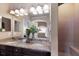 Elegant bathroom featuring dual sinks, granite countertops, a large mirror, and a luxurious shower at 12031 Longview Lake Cir, Lakewood Ranch, FL 34211