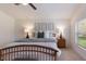 Cozy bedroom boasts natural light, complemented by a comfortable bed and tasteful decor at 12031 Longview Lake Cir, Lakewood Ranch, FL 34211