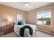 Cozy bedroom with a view of the lake through a sunny window and complete with stylish furnishings and decor at 12031 Longview Lake Cir, Lakewood Ranch, FL 34211