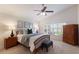 Comfortable bedroom featuring a ceiling fan, vaulted ceiling, and large window with a pleasant outdoor view at 12031 Longview Lake Cir, Lakewood Ranch, FL 34211
