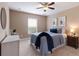 Well-lit bedroom features neutral walls, complemented by a cozy bed and ample natural light from a window at 12031 Longview Lake Cir, Lakewood Ranch, FL 34211