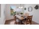 Cozy dining area with wood table, chandelier, and natural light from a large window, perfect for Gathering meals at 12031 Longview Lake Cir, Lakewood Ranch, FL 34211