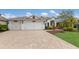 Lovely home with a three-car garage, a paver driveway and colorful, mature landscaping at 12031 Longview Lake Cir, Lakewood Ranch, FL 34211