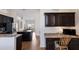Spacious kitchen featuring dark cabinetry, granite countertops, and stainless steel appliances with office workspace at 12031 Longview Lake Cir, Lakewood Ranch, FL 34211