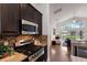 Modern kitchen with stainless steel appliances, granite countertops, and seamless view to the living area at 12031 Longview Lake Cir, Lakewood Ranch, FL 34211