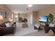 Cozy living room with a comfortable leather sofa, plush rug, and entertainment area with a view of a beach on the TV at 12031 Longview Lake Cir, Lakewood Ranch, FL 34211