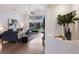 Bright living room featuring vaulted ceilings, large windows, view of the water, and modern furnishings at 12031 Longview Lake Cir, Lakewood Ranch, FL 34211