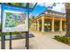 Informative map of Central Park with walking trails next to a covered picnic area with blue picnic tables at 12031 Longview Lake Cir, Lakewood Ranch, FL 34211