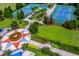 Aerial view of two blue tennis courts surrounded by lush landscaping and palm trees at 12031 Longview Lake Cir, Lakewood Ranch, FL 34211