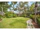 Well-maintained backyard with a manicured lawn and stone path at 1207 71St Nw St, Bradenton, FL 34209