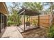 Charming backyard featuring a cozy pergola, lounge chairs, landscaping, and a privacy fence for a tranquil retreat at 1207 71St Nw St, Bradenton, FL 34209