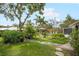 Lush backyard with tropical plants and a stepping stone path leading to the pool at 1207 71St Nw St, Bradenton, FL 34209
