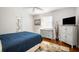Bright bedroom with a bed, TV, decor and hardwood floors at 1207 71St Nw St, Bradenton, FL 34209