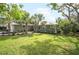 A beautiful home featuring lush tropical landscaping with palm trees and a manicured lawn at 1207 71St Nw St, Bradenton, FL 34209