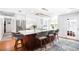 Modern kitchen featuring white cabinets, stainless steel appliances, and a large island with bar seating at 1207 71St Nw St, Bradenton, FL 34209
