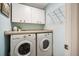 Efficient laundry room featuring a washer, dryer, storage cabinets, and a countertop space for folding and organizing at 1207 71St Nw St, Bradenton, FL 34209