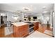 Open concept living space with wooden floors, kitchen island, fireplace, and lots of light at 1207 71St Nw St, Bradenton, FL 34209