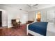Cozy main bedroom featuring a large bed, stylish decor, hardwood floors, and an ensuite at 1207 71St Nw St, Bradenton, FL 34209
