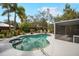 Landscaped backyard with a stunning pool, lush foliage, and patio area for relaxing or entertaining in style at 1207 71St Nw St, Bradenton, FL 34209