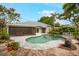 Beautiful backyard with a pool, lounge chairs, landscaping, and a screened-in lanai for outdoor entertaining at 1207 71St Nw St, Bradenton, FL 34209