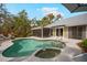 Inviting backyard pool and spa area with lush landscaping, complemented by a screened-in patio for relaxing at 1207 71St Nw St, Bradenton, FL 34209