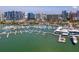 An aerial view of a marina with boats docked in the water and buildings in the background at 1233 N Gulfstream Ave # 401, Sarasota, FL 34236
