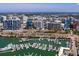 An aerial view shows a high-rise condo in a waterfront neighborhood with lush landscaping, a roundabout and water views at 1233 N Gulfstream Ave # 401, Sarasota, FL 34236