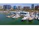 An aerial view of a marina with boats docked in the water and buildings in the background at 1233 N Gulfstream Ave # 401, Sarasota, FL 34236