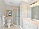 Bathroom with patterned wallpaper, glass shower, and sink with vanity at 1233 N Gulfstream Ave # 401, Sarasota, FL 34236