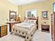 Cozy bedroom featuring wicker furniture and a decorative quilted bedspread at 1233 N Gulfstream Ave # 401, Sarasota, FL 34236
