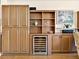 Custom built-in bar features cabinetry, shelving, and a wine fridge at 1233 N Gulfstream Ave # 401, Sarasota, FL 34236